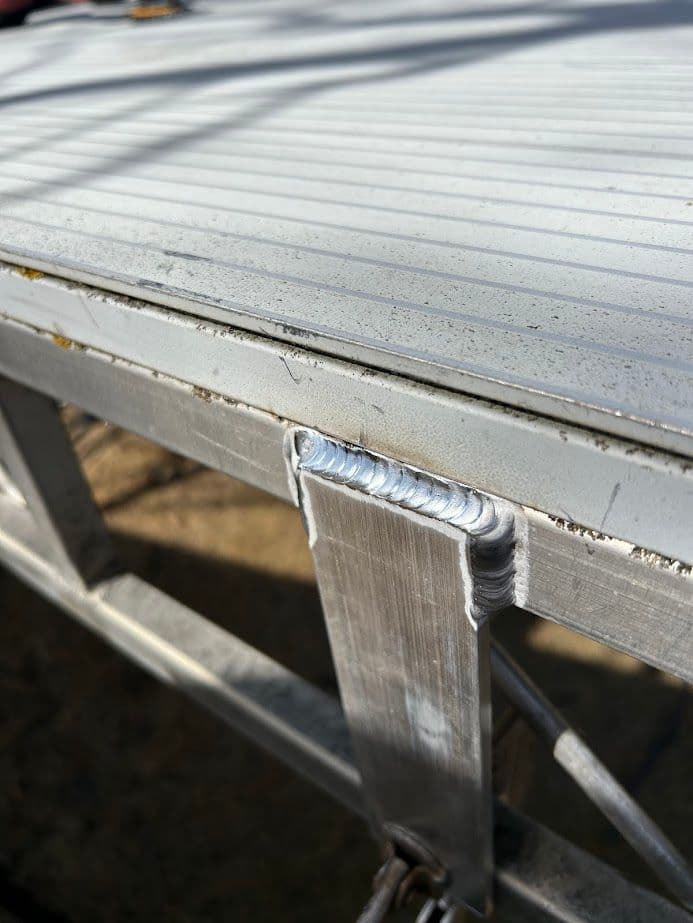 Close-up of a metal surface with visible welding seam and industrial finish.
